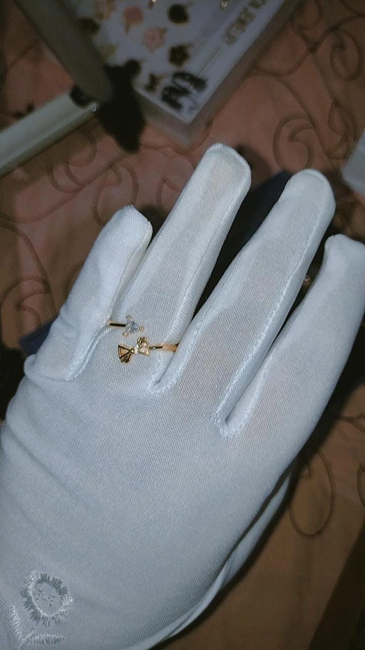 This delicate gold-tone open adjustable ring features an asymmetric wrap-around design.