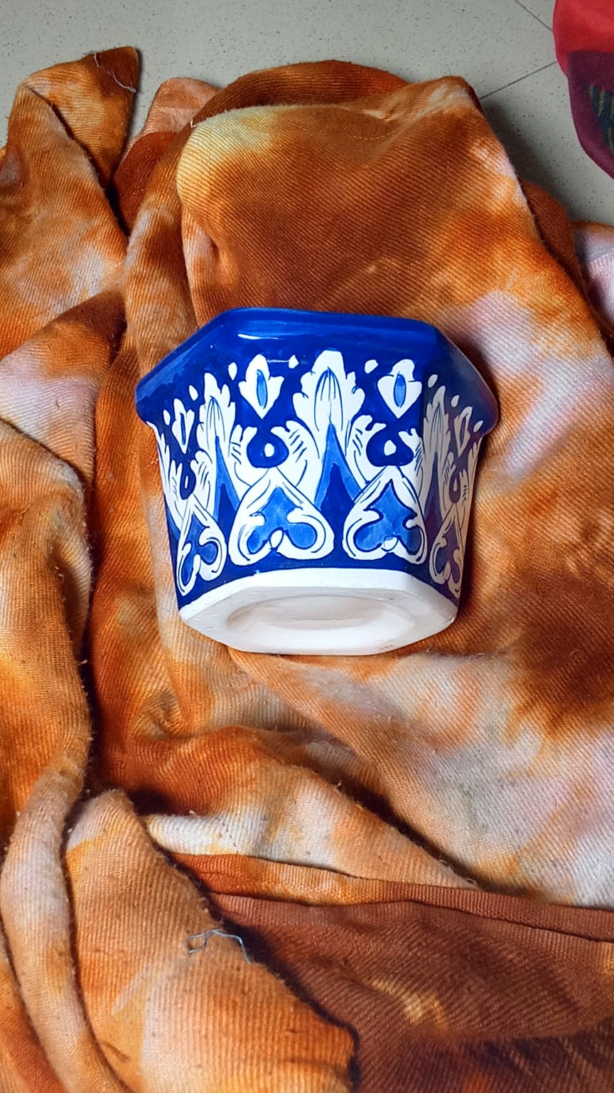 hand-painted Multan blue pottery (Kashi Kari) planter features traditional cobalt blue and white floral artwork with a glossy glazed finish. Its hexagonal shape makes it a versatile piece for home decor, plant display, or tabletop accenting.